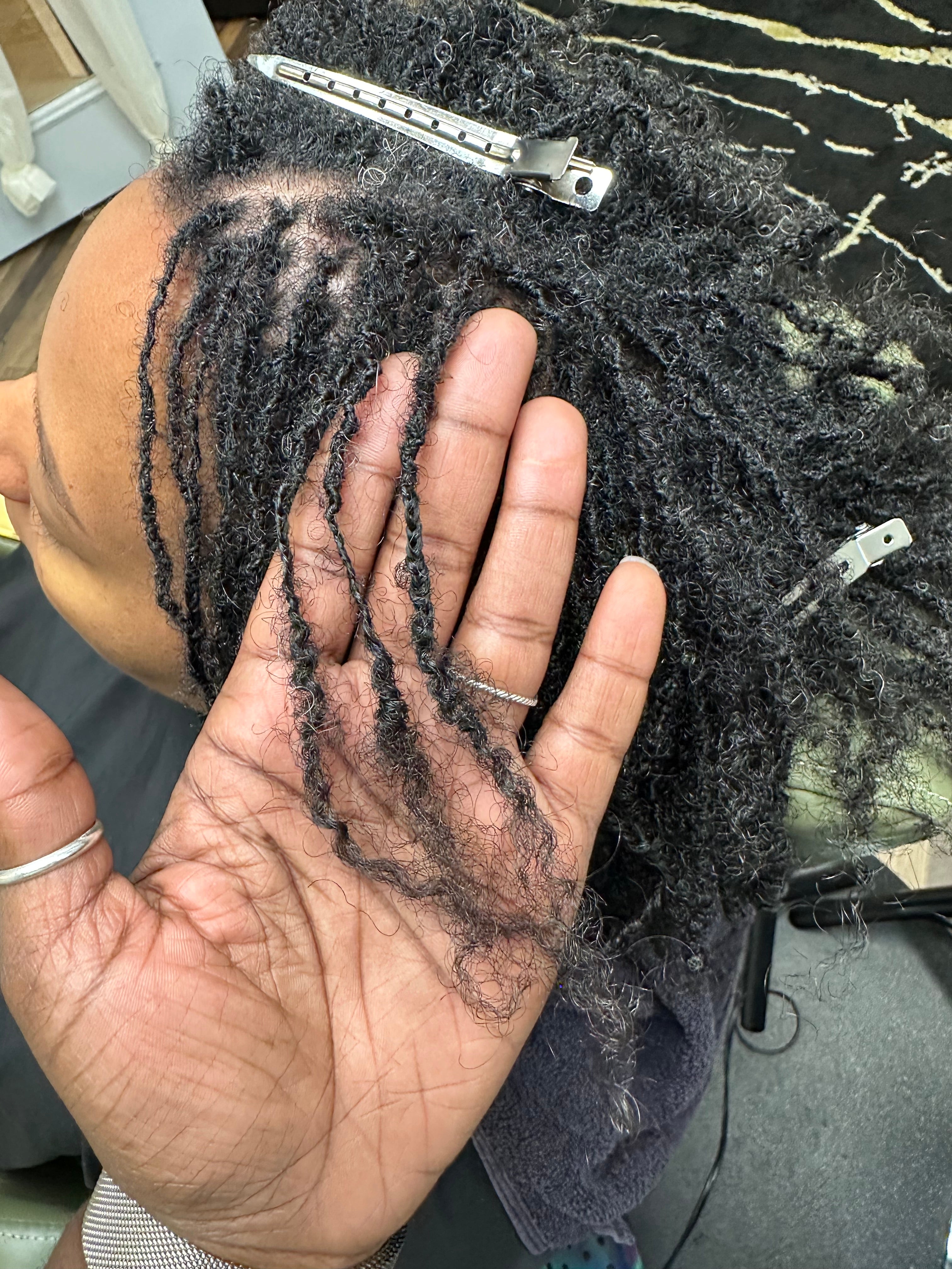 Close-up of Microlocs and scalp during hands-on work at Heal Thy Hair