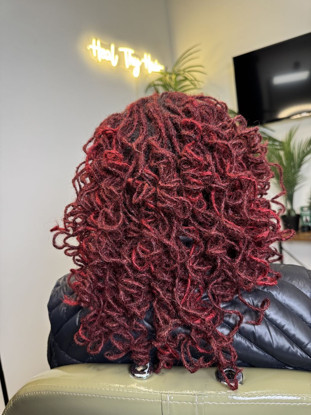 Burgundy color Microlocs styled in defined curls